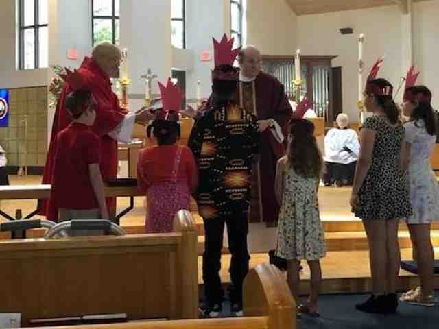 Children receiving a blessing on Pentecost